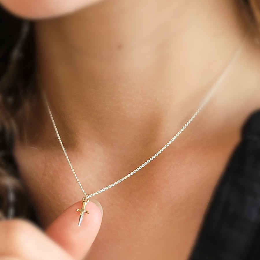 Tiny dagger charm necklace in Sterling silver with Bronze accent on a delicate silver chain by Studio Blue on Etsy.