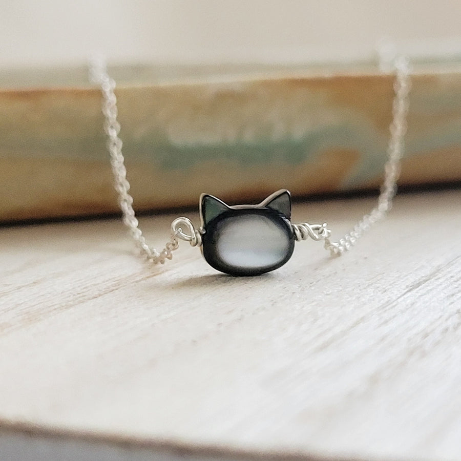 Mother of Pearl cat necklace. Black Mother of Pearl carved cat charm on delicate chain in sterling silver, by Studio Blue on Etsy