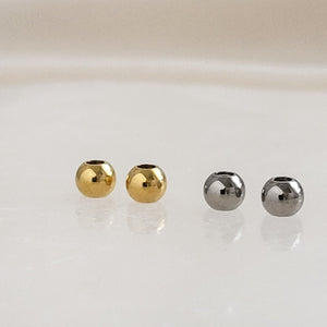 Two pairs of Titanium Ball backs with silicone center, one pair in silver, one pair in 14k gold plate on white background, by Studio Blue on Etsy