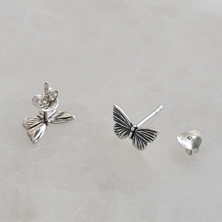 Pair of Sterling silver Butterfly studs earrings shown on white background by Studio Blue on Etsy