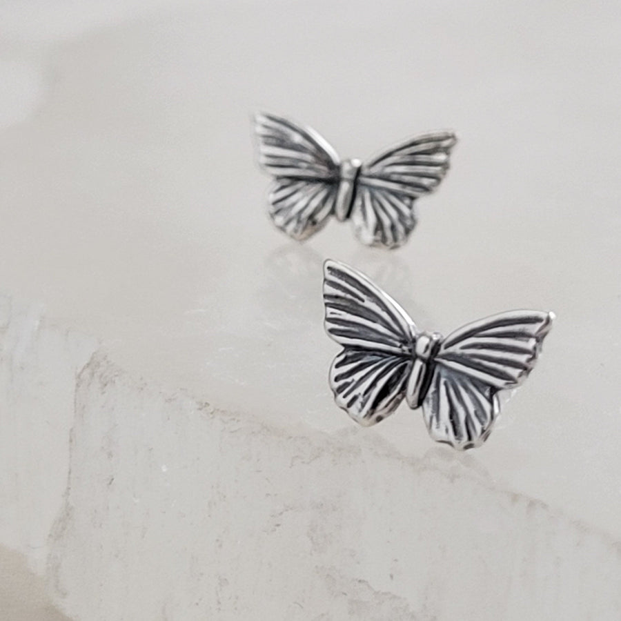 Pair of Sterling silver Butterfly studs earrings shown on white background by Studio Blue on Etsy