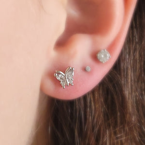 Diamond CZ Butterfly studs in 316L Surgical steel shown on model. Screw-in, flat-back nap studs by Studio Blue on Etsy