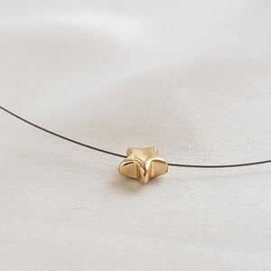 Golden Pyrite Star necklace on black filament, shown on white background by Studio Blue on Etsy