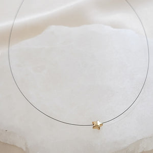 Golden Pyrite Star necklace on black filament, shown on white background by Studio Blue on Etsy