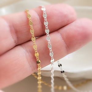 Dainty shimmer chain shown in 14k gold fill & sterling silver on two fingers by Studio Blue on Etsy