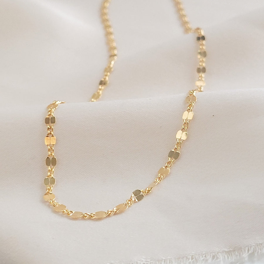 Dainty shimmer chain in 14k gold fill on beige material by Studio Blue on Etsy