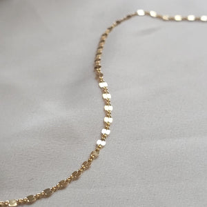 Dainty shimmer chain in 14k gold fill on beige material by Studio Blue on Etsy