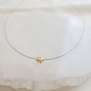 Golden Pyrite Star necklace on black filament, shown on white background by Studio Blue on Etsy